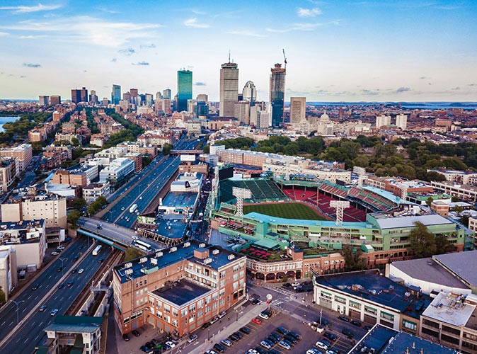 An aerial view of the city of Boston with Fenway Park most prominently pictured
