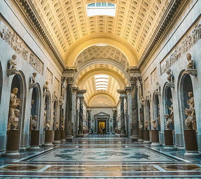 A museum hall lined with statues on both sides