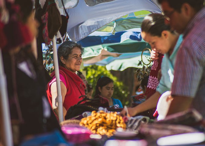 Locals and expats at a market stand in Oaxaca