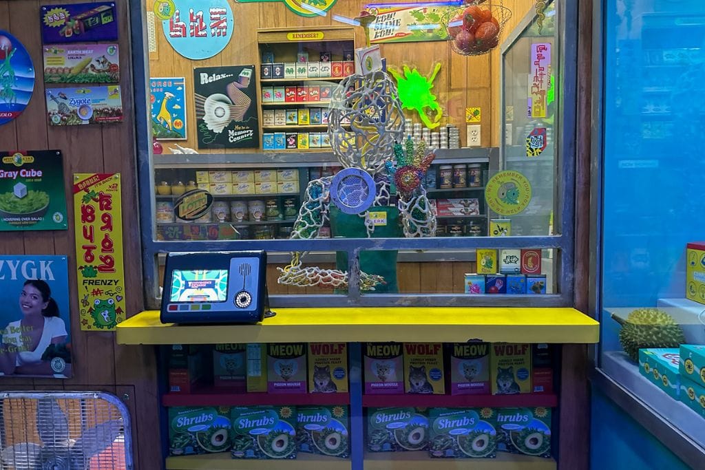A picture of a makeshift snack shop with a Q-pass terminal in the corner.