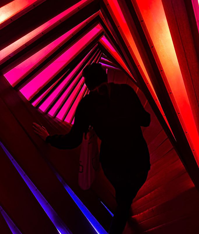 A picture of Kristin's friend walking through a twisted staircase.