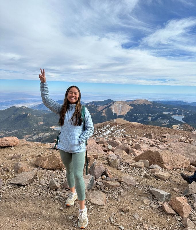 A picture of Kristin on top of Pikes Peak in Colorado.