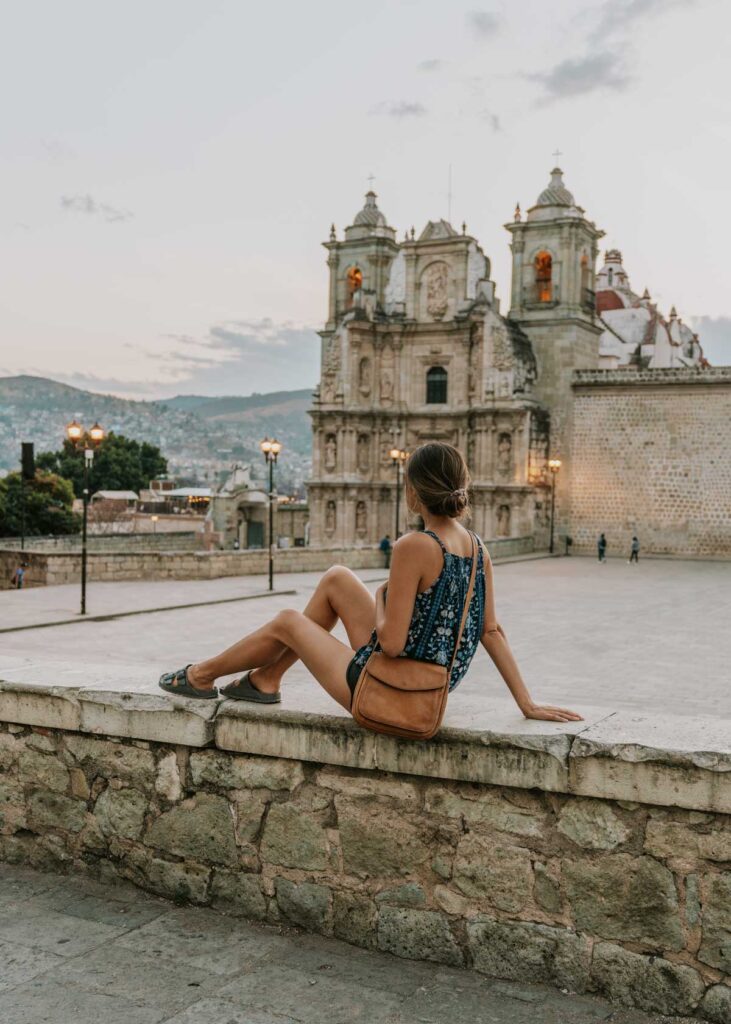 Woman sitting in front of a church in Oaxaca