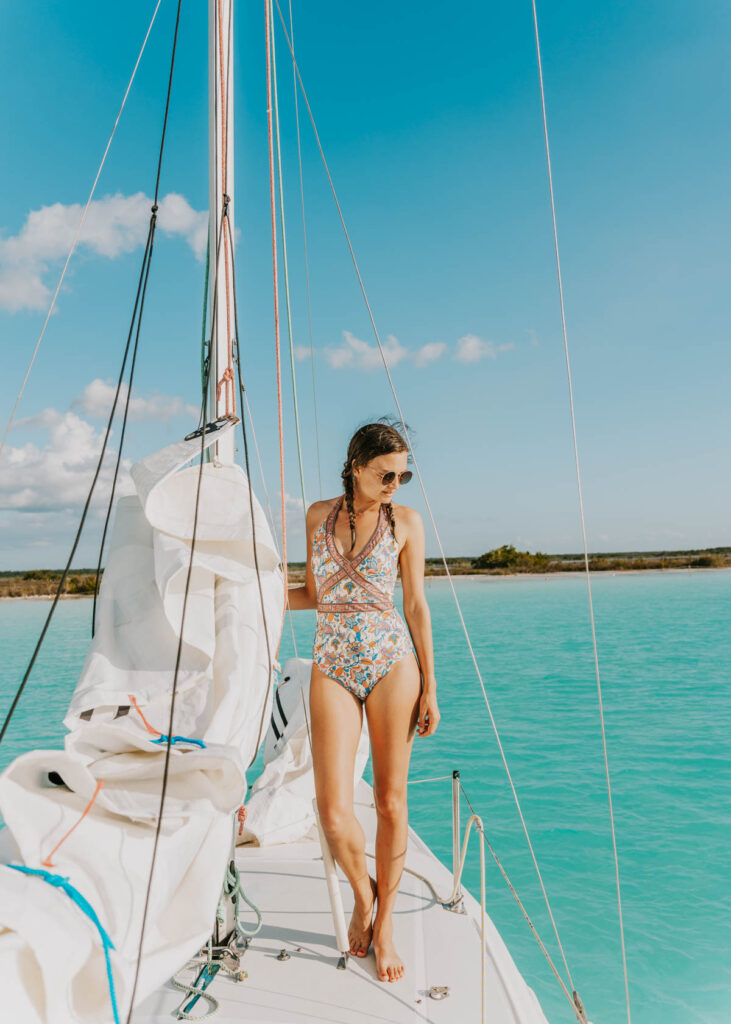 Standing on a sailboat on laguna Bacalar, a must do activity on any Bacalar itinerary