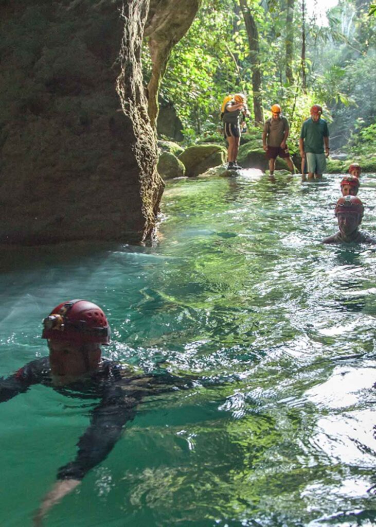 Swimming through deep water at the entrance of the ATM Cave