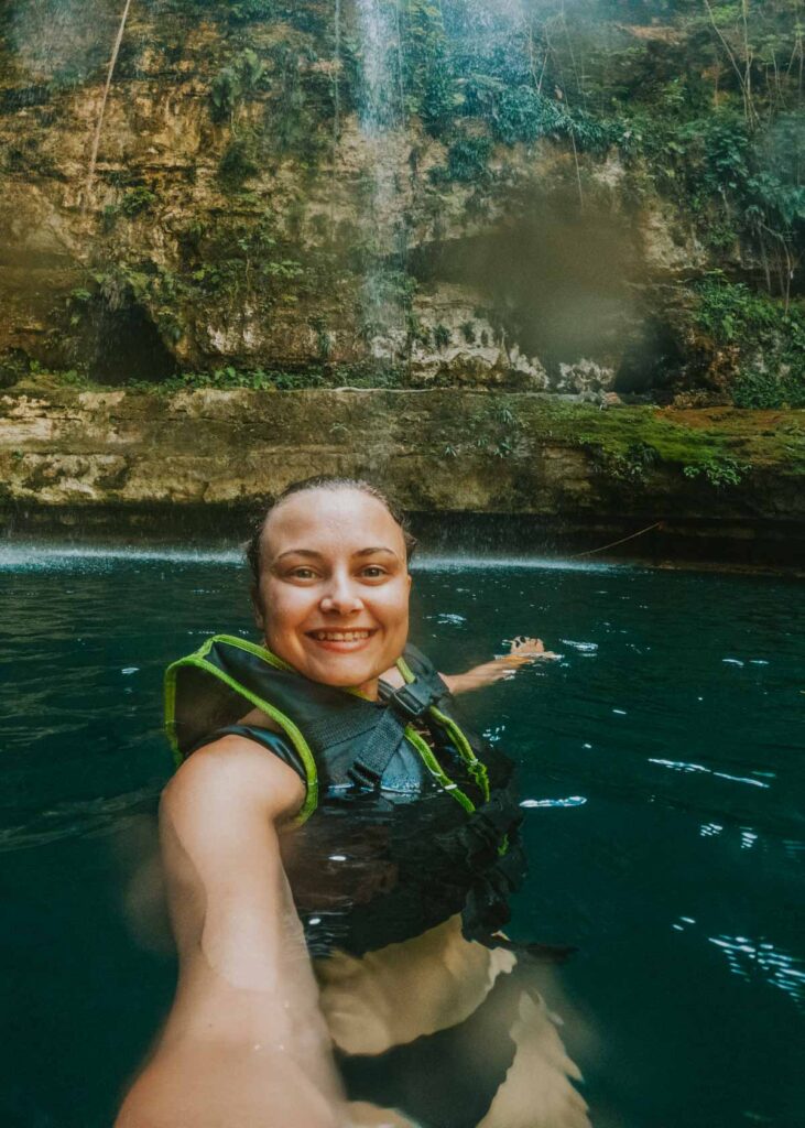 Selfie of woman swimming in a cenote in Valladolid, Mexico