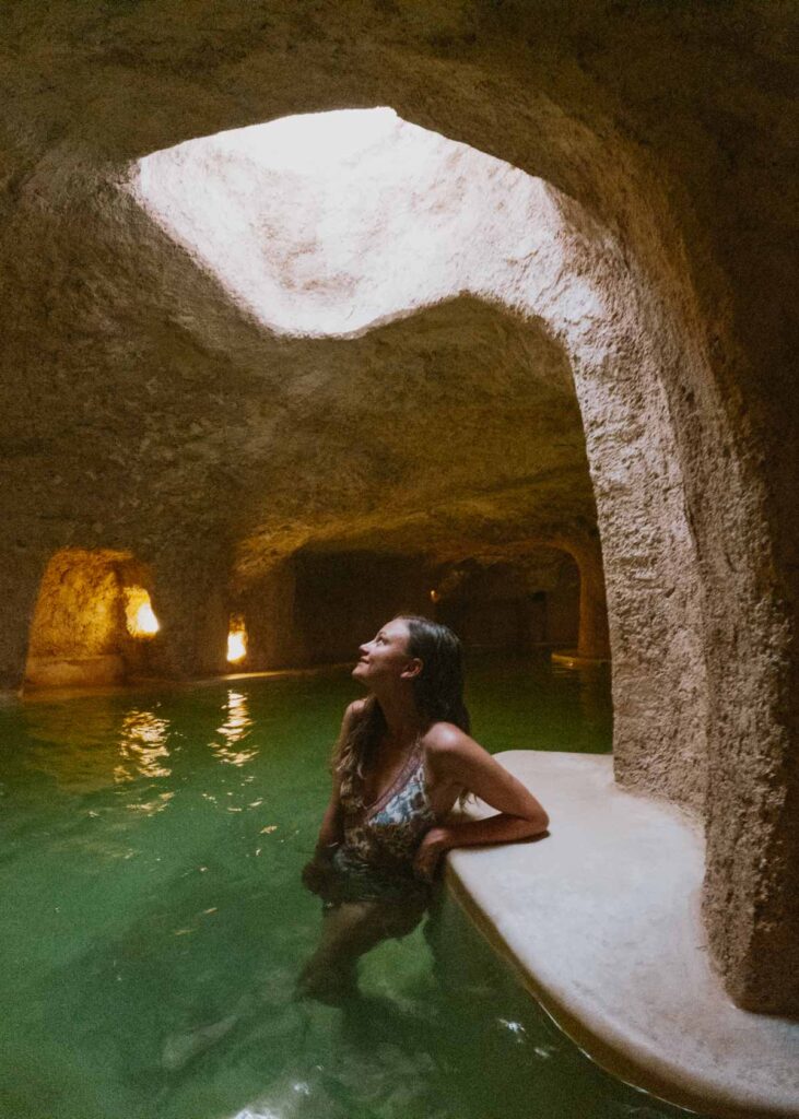 Woman standing in cave pool at Zentik, my recommended hotel for this 5 day Valladolid itinerary 
