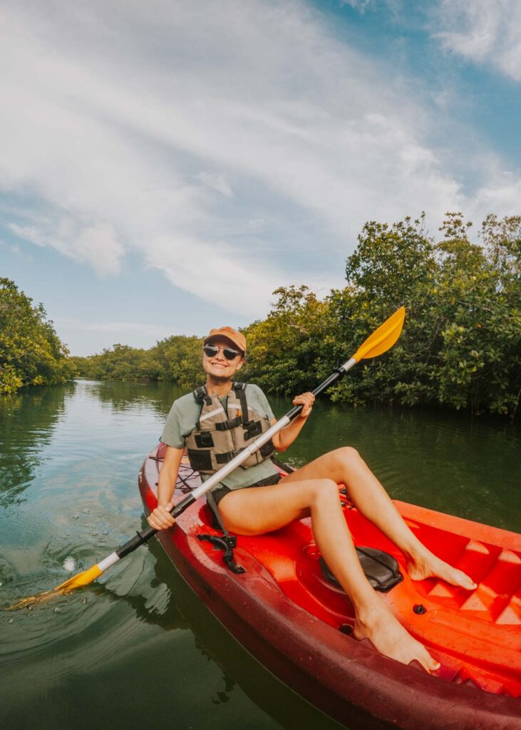 Woman kayaking through the mangroves in Cancun, my favorite way to explore Cancun off the beaten path