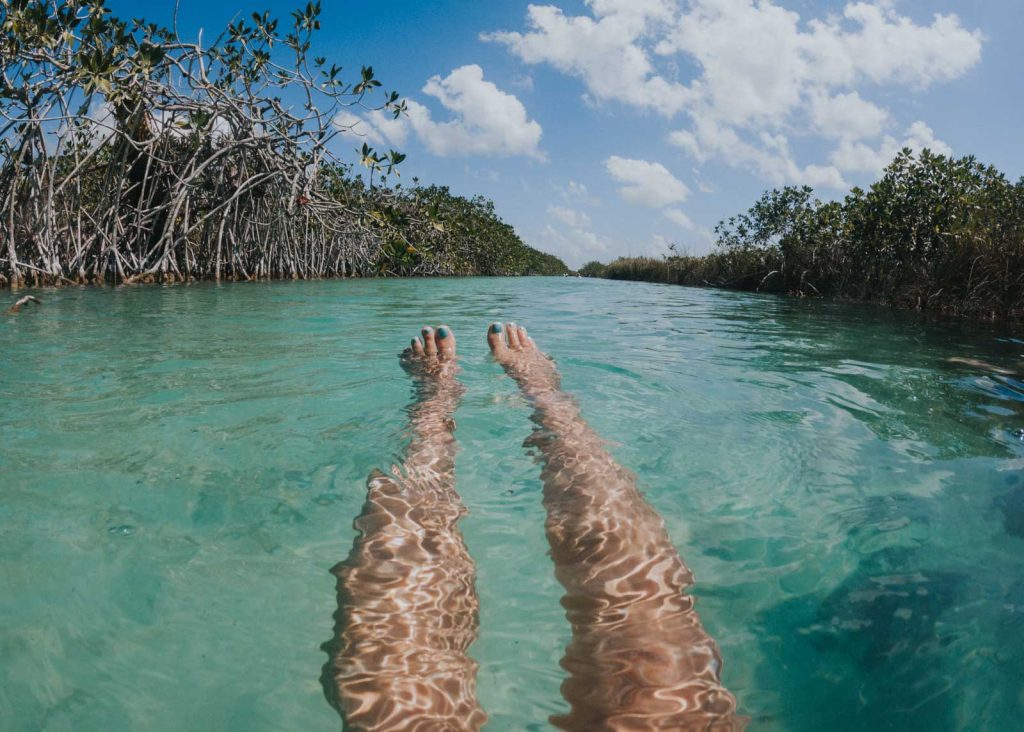 Legs floating down the Muyil River Float near Cancun