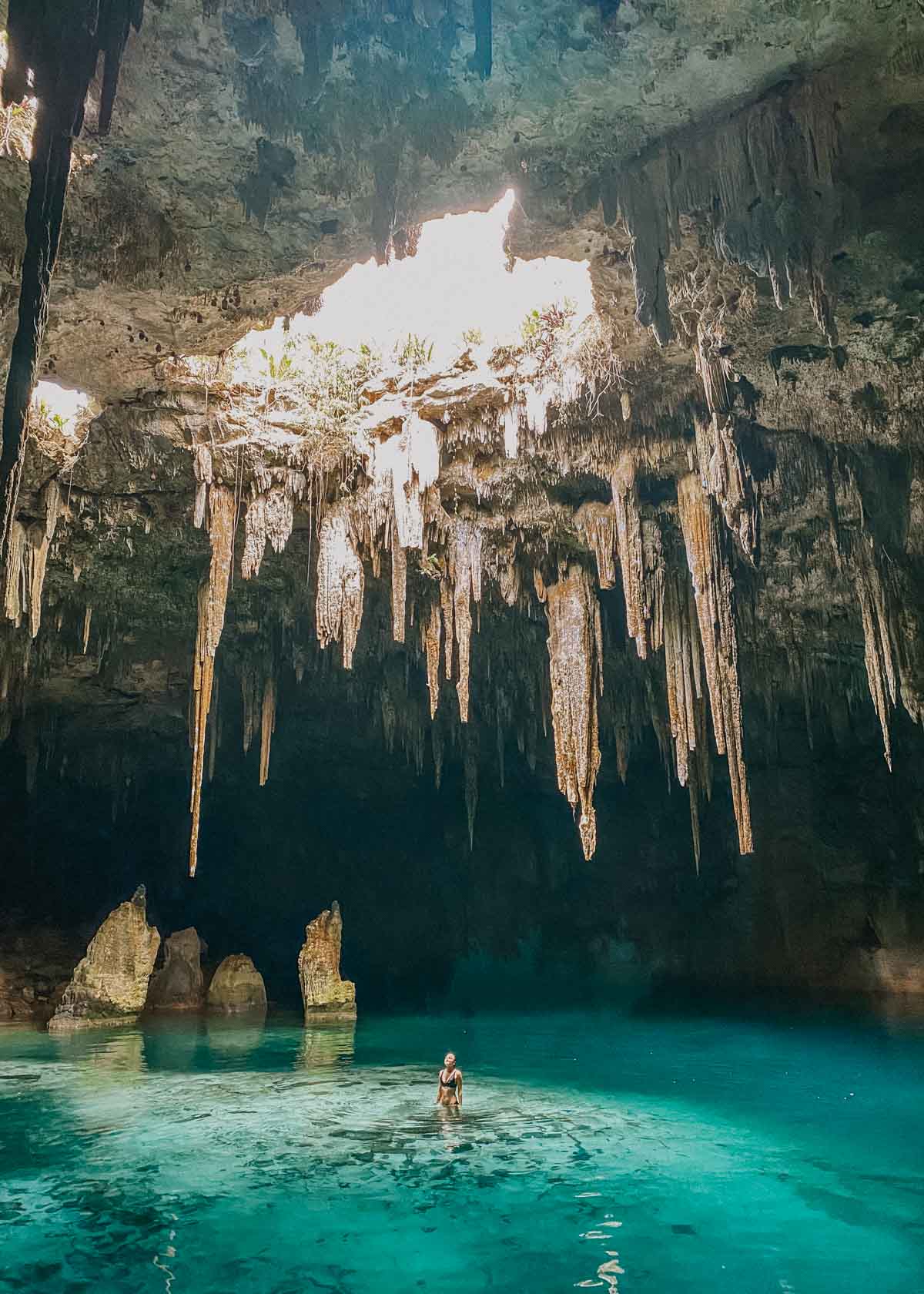 Woman standing in the water in a cenote in Mexico